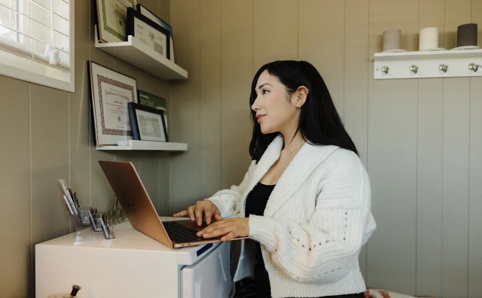 Business owner working on her website at a desk