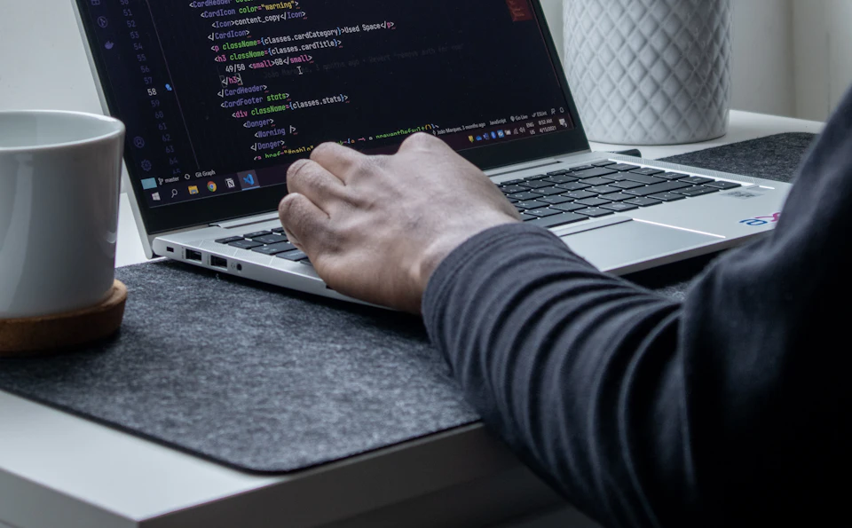 Developer fixing code on a laptop