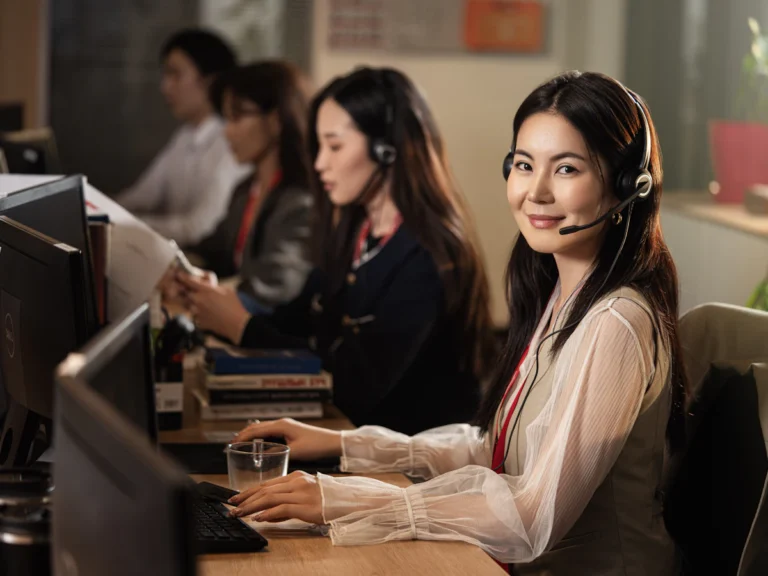 Support specialist with a headset working at a computer